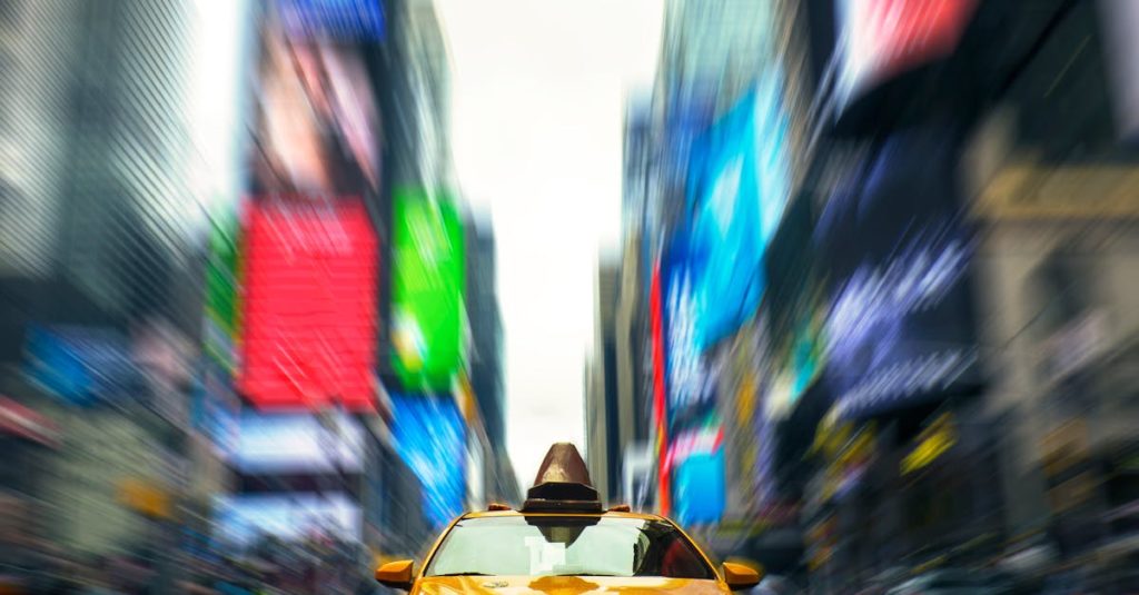 Dynamic view of a yellow taxi cab speeding through Times Square, New York.